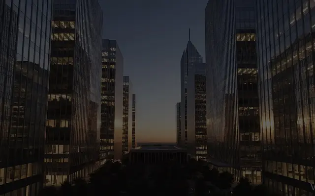 Modern buildings in an urban setting at dusk.